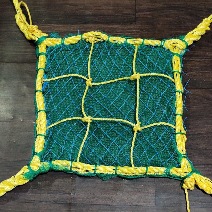 Fine mesh debris containment net on a building facade